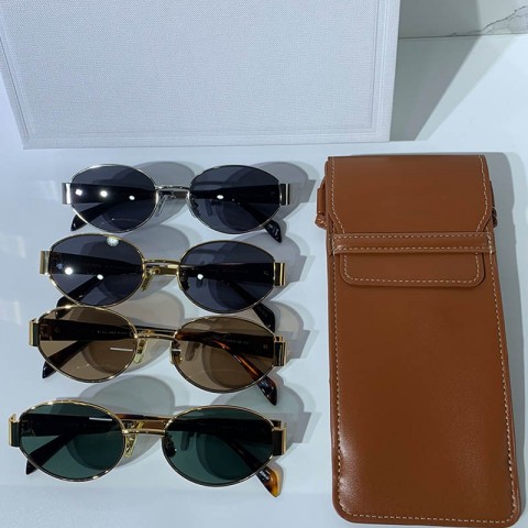 Celins Women's Oval Sunglasses with Gold Legs and Green Lenses