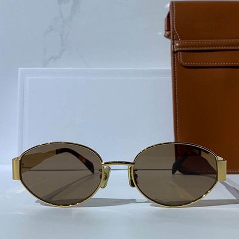 Celins Women's Oval Sunglasses with Gold Legs and Green Lenses